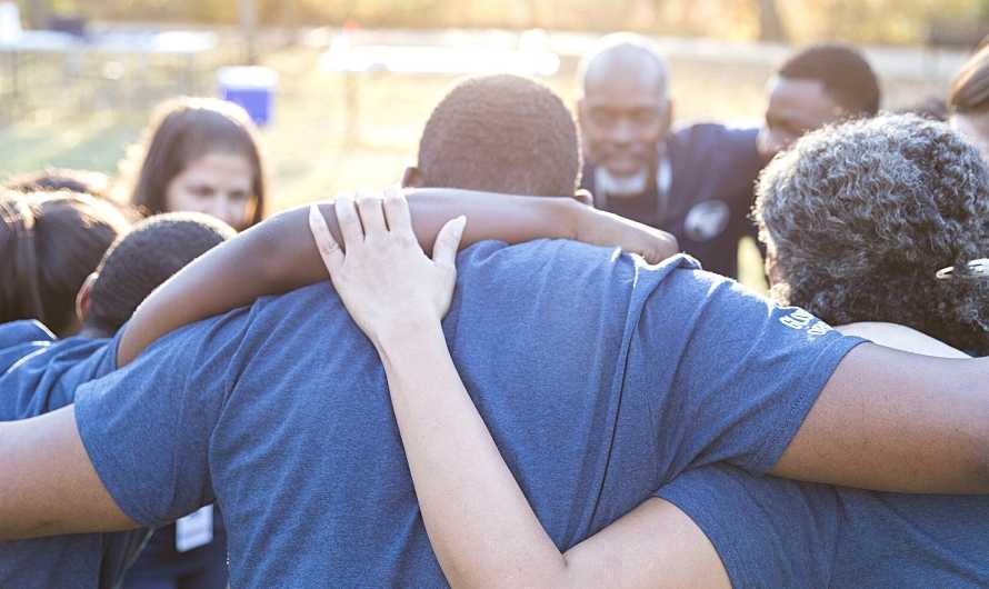 Picture of a group of people in a team huddle.