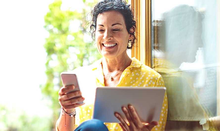 Picture of a women looking at a smart phone.